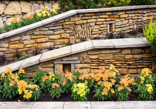 Beautiful retaining wall rock-veneer wall outside a home in Pelham, NH